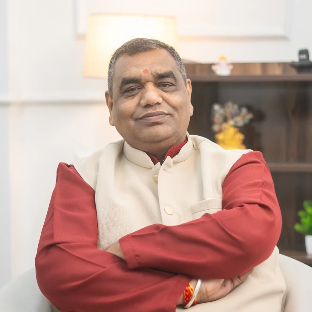 Acharya Chetan Joshi in a cream waistcoat and maroon kurta